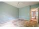 Light green bedroom needing updates; door shows view into another room at 425 Fieldstone Lndg, Alpharetta, GA 30005