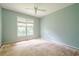 Bedroom with a ceiling fan and large window; ready to be updated at 425 Fieldstone Lndg, Alpharetta, GA 30005