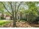 Brick two-story home with a manicured lawn and mature trees, complete with an attached garage and arched doorway at 425 Fieldstone Lndg, Alpharetta, GA 30005
