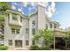 Back exterior of a house with multiple windows, a deck, and mature trees for privacy and shade at 425 Fieldstone Lndg, Alpharetta, GA 30005