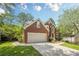 Attractive brick two-story home with an attached garage, bay window, and well-maintained landscaping at 425 Fieldstone Lndg, Alpharetta, GA 30005