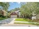 Charming two-story brick home with an attached garage, lush green lawn, and mature shade trees at 425 Fieldstone Lndg, Alpharetta, GA 30005