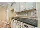 Close-up of the kitchen counter with stone countertops and decorative tile backsplash at 425 Fieldstone Lndg, Alpharetta, GA 30005