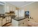 Kitchen with island, stainless steel appliances, and custom cabinetry at 425 Fieldstone Lndg, Alpharetta, GA 30005