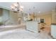 Open kitchen with a bar counter and a view into the adjacent living room at 425 Fieldstone Lndg, Alpharetta, GA 30005