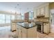 Open kitchen featuring an island, stainless steel appliances, and custom cabinetry at 425 Fieldstone Lndg, Alpharetta, GA 30005