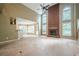 Open-concept living room with a brick fireplace and tall windows at 425 Fieldstone Lndg, Alpharetta, GA 30005