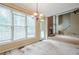 Bright living room with large windows, brick fireplace, and staircase at 425 Fieldstone Lndg, Alpharetta, GA 30005