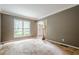 A spacious living room with natural light shining in through the large window at 425 Fieldstone Lndg, Alpharetta, GA 30005
