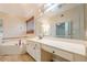 Ensuite bathroom featuring double sinks, a bathtub, and lots of counter and cabinet space at 425 Fieldstone Lndg, Alpharetta, GA 30005