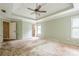 Large main bedroom with ensuite bathroom, neutral paint, tray ceiling, ceiling fan, and lots of natural light at 425 Fieldstone Lndg, Alpharetta, GA 30005