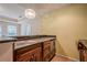 Wet bar area featuring dark wooden cabinets, granite countertop, and space for appliances, perfect for entertaining at 425 Fieldstone Lndg, Alpharetta, GA 30005