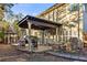 Backyard view with covered patio, outdoor kitchen, stone pathways, and gazebo at 5105 Riverthur Pl, Duluth, GA 30096
