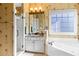 Traditional bathroom featuring a separate shower, soaking tub, floral wallpaper, and vanity with storage space at 5105 Riverthur Pl, Duluth, GA 30096