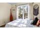 Serene bedroom with large window, letting in natural light and offering a view of the trees outside at 5105 Riverthur Pl, Duluth, GA 30096