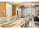 Well lit dining room with hardwood floors, decorative wallpaper, and adjacent living area at 5105 Riverthur Pl, Duluth, GA 30096