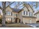Charming two-story home boasts a well-maintained lawn and a two-car garage at 5105 Riverthur Pl, Duluth, GA 30096