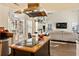 Open kitchen with stainless appliances, island cooktop, leading to bright living area at 5105 Riverthur Pl, Duluth, GA 30096