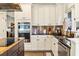 Modern kitchen features stainless steel appliances, and white cabinetry at 5105 Riverthur Pl, Duluth, GA 30096