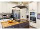 Spacious kitchen features stainless steel appliances, granite countertops and custom cabinets at 5105 Riverthur Pl, Duluth, GA 30096