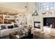 Open concept living room boasts fireplace, large windows, hardwood floors, and seamlessly connects to the modern kitchen at 5105 Riverthur Pl, Duluth, GA 30096