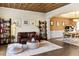 Open concept living room with hardwood floors, decorative ceiling, and adjacent dining area at 5105 Riverthur Pl, Duluth, GA 30096
