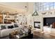 Bright living room features a cozy fireplace, mantle decor, and a comfortable couch at 5105 Riverthur Pl, Duluth, GA 30096