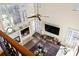 Aerial view of the living room featuring a fireplace, large windows, and a comfortable seating arrangement at 5105 Riverthur Pl, Duluth, GA 30096