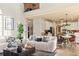 Open floor plan with living room and kitchen featuring modern appliances and hardwood floors at 5105 Riverthur Pl, Duluth, GA 30096