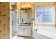 Bright bathroom features floral wallpaper, soaking tub, and glass-door shower at 5105 Riverthur Pl, Duluth, GA 30096