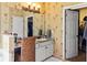 Bathroom featuring floral wallpaper, a vanity with granite counters, and a view of the closet at 5105 Riverthur Pl, Duluth, GA 30096