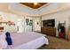 Main bedroom with tray ceilings, a view of the TV and a glimpse of the closet space at 5105 Riverthur Pl, Duluth, GA 30096