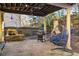 Covered patio with stone flooring, egg chair, outdoor grill, and water feature at 5105 Riverthur Pl, Duluth, GA 30096