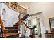Bright foyer features a staircase with carpeted treads, wood and wrought iron banister and high ceilings at 5105 Riverthur Pl, Duluth, GA 30096