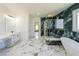 Luxurious bathroom with marble floors, soaking tub, and a glass-enclosed shower at 972 Auburn Rd, Dacula, GA 30019