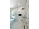Modern bathroom featuring a luxurious walk-in shower with marble tile and gold fixtures at 972 Auburn Rd, Dacula, GA 30019