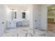 Elegant bathroom with dual vanities, marble floors, and modern lighting at 972 Auburn Rd, Dacula, GA 30019