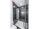 Contemporary bathroom showcasing a glass enclosed shower with marble tiling and modern fixtures at 972 Auburn Rd, Dacula, GA 30019