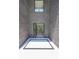 Contemporary entryway with soaring ceilings, brick accent wall, and stylish tile design at 972 Auburn Rd, Dacula, GA 30019
