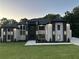 Striking two-story home featuring a manicured lawn and modern architectural details and integrated lighting at 972 Auburn Rd, Dacula, GA 30019