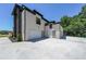 Exterior showcases a modern home with a three-car garage and clean curb appeal at 972 Auburn Rd, Dacula, GA 30019