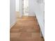 Hallway featuring hardwood floors, white trim, and a built-in bench with storage at 972 Auburn Rd, Dacula, GA 30019