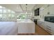 Modern kitchen with a spacious island, stainless steel appliances, and an open floor plan at 972 Auburn Rd, Dacula, GA 30019