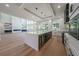 Bright modern kitchen features island, wine cooler and stainless appliances in an open layout at 972 Auburn Rd, Dacula, GA 30019