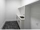 Functional laundry room featuring modern cabinetry, quartz countertops, and stylish patterned flooring at 972 Auburn Rd, Dacula, GA 30019