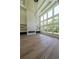Bright living space with floor-to-ceiling windows, marble fireplace, and soaring ceiling with stylish light fixture at 972 Auburn Rd, Dacula, GA 30019