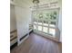 Bright living room with fireplace, custom shelving, hardwood floors, and big windows overlooking the backyard at 972 Auburn Rd, Dacula, GA 30019