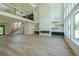 Living room features hardwood floors, large windows, fireplace, open to a mezzanine and staircase at 972 Auburn Rd, Dacula, GA 30019