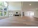 Open-concept living space with hardwood floors, large windows, and modern finishes at 972 Auburn Rd, Dacula, GA 30019