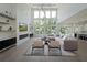 Bright, open living room with high ceilings, large windows, modern decor and fireplace at 972 Auburn Rd, Dacula, GA 30019